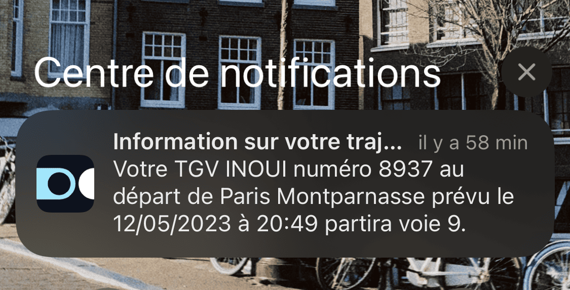 Push message on a phone. Title 'Information about your journey...' followed by the text 'Your TGV INOUI number 8937 departing from Paris Montparnasse scheduled for 12/05/2023 at 8:49 PM will depart from platform 9.'